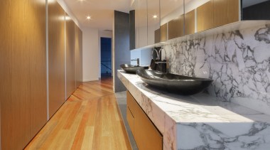 ​​​​​​​The pathway to the master bedroom in this gray, orange, brown