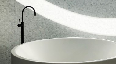 Curved tub, curved mosaic wall and curved light 