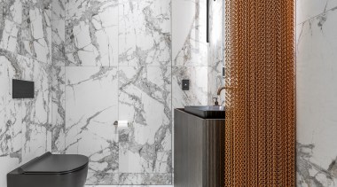 An aged-brass chain hanging curtain creates a division 