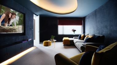 Indirect lighting and dark wall tones set the 