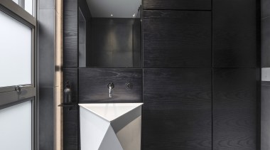 The custom-made timber clad veneer wall acts as 