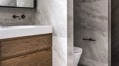 The bathroom's chunky blade walls divide vanity, toilet 