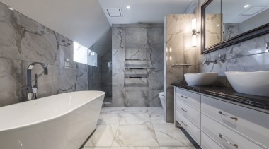 Limiting the designs materials and hues created a architecture, bathroom, bathtub, building, ceiling, estate, floor, flooring, furniture, home, house, interior design, plumbing fixture, property, real estate, room, tap, tile, wall, gray