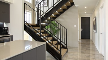 The dramatic steel and wood staircase not only 