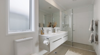 The upstairs bathroom with large shower and wall-hung 