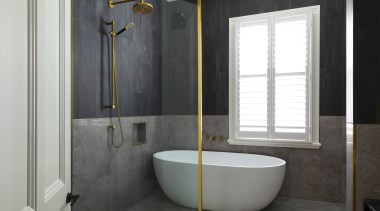 A glass screen with brass trim provides partial 