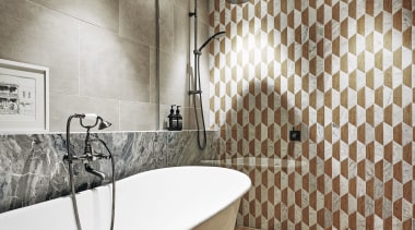 This bathroom features timber-look floor tiles by Earp 