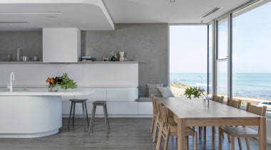 By eliminating overhead cabinets and obscuring the rangehood 