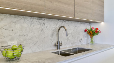 Recessed LED strips accentuate the handless perimeter cabinetry. 