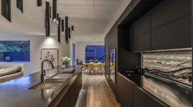 An exotic veined stone splashback offsets the kitchen's 
