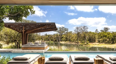 At the new Cheetah Plains lodge in Kruger backyard, building, deck, furniture, home, house, interior design, landscape, landscaping, leisure, natural landscape, outdoor furniture, patio, property, real estate, room, shade, table, tree, brown, white