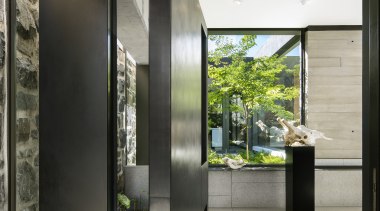 The substantial pivot front door swings into the 