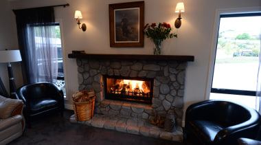 Feature river stone open fire surroundSince the early fireplace, hearth, home, house, interior design, living room, real estate, room, wood burning stove, black