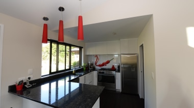 Kitchen design features red hot chilli splash back. house, interior design, property, real estate, gray