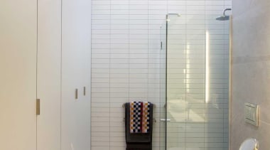 The shower is positioned beneath a skylight. - bathroom, ceiling, daylighting, interior design, plumbing fixture, room, tile, gray