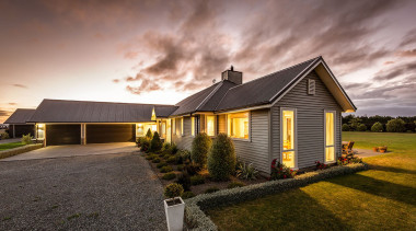 Built to last the test of time, this cloud, cottage, estate, evening, facade, farmhouse, grass, home, house, landscape, property, real estate, residential area, roof, sky, suburb, sunlight, gray