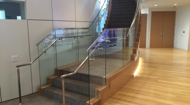 Curved tempered glass designed with precision measurements makes floor, flooring, glass, handrail, stairs, gray