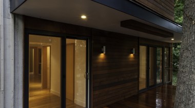 The deck openings are all sheltered - The architecture, deck, facade, floor, home, house, lighting, real estate, siding, window, wood, wood flooring, black