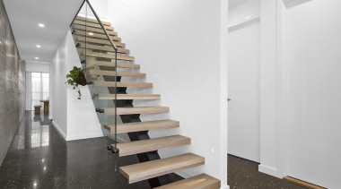 A floating stair with glass balustrade runs up architecture, daylighting, floor, flooring, handrail, interior design, product design, stairs, white