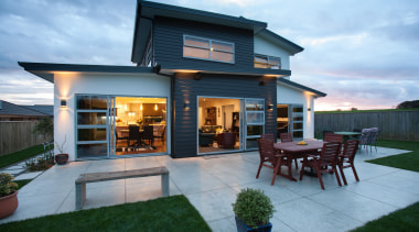 The rear view of this dual plaster and backyard, facade, home, house, property, real estate, teal