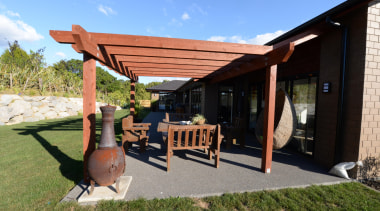 A patio with timber based decor at a backyard, house, outdoor structure, pergola, property, real estate