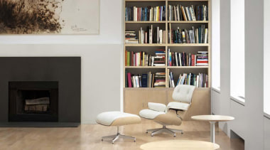 Eames lounge chair and ottoman by Charles and bookcase, chair, floor, flooring, furniture, hearth, interior design, living room, product design, shelf, shelving, table, wall, gray