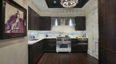 This space is glamour personified. The walls are cabinetry, ceiling, countertop, cuisine classique, floor, flooring, interior design, kitchen, property, real estate, room, black, gray