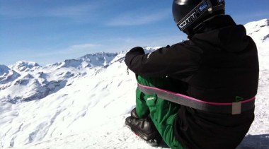 Designed by Alejandro Aravena, Chairless is a robust adventure, extreme sport, geological phenomenon, glacial landform, headgear, helmet, mountain, mountain range, mountaineer, mountaineering, mountainous landforms, personal protective equipment, piste, ridge, ski, ski binding, ski equipment, ski helmet, skiing, sky, snow, snowboard, sports equipment, summit, terrain, vacation, winter, winter sport, white, black, teal