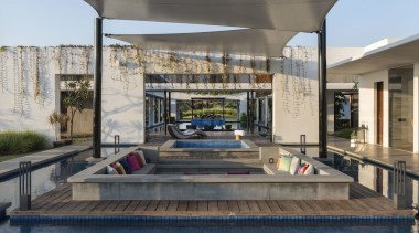 A sunken seating area outside receives shelter from real estate, gray