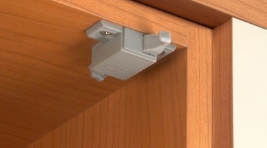 An adjustable, self-opening mechanical push system for handleless angle, lighting, product design, wood, wood stain, brown, orange