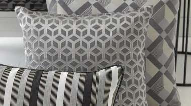 Luxe. n. The condition of being elegantly sumptuous couch, cushion, duvet cover, furniture, linens, living room, pattern, pillow, throw pillow, gray, black, white