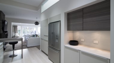 The kitchen highlights a double door stainless steel countertop, floor, interior design, kitchen, real estate, gray