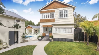 A path winds up the front steps - backyard, cottage, elevation, estate, facade, home, house, neighbourhood, property, real estate, residential area, siding, villa, yard, white, brown