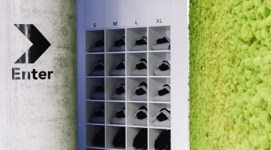 The green moss walls runs alongside the entrance wall, gray