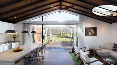 The villa’s deck offers an additional exterior living ceiling, daylighting, house, interior design, real estate, roof, window, gray, black