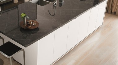 An elegant brown-grey marble with subtle swirls in coffee table, countertop, floor, flooring, furniture, kitchen, product design, sideboard, table, tile, wood stain, white