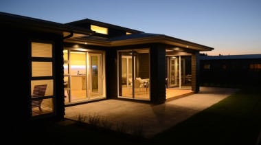 This ever so practical layout with fantastic indoor estate, evening, facade, home, house, lighting, property, real estate, residential area, shed, sky, window, black