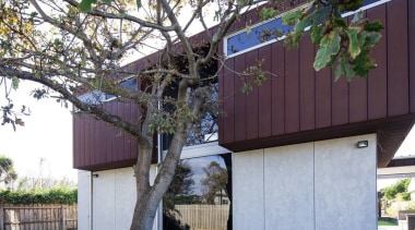 The wood has been layered on top of architecture, building, cottage, facade, home, house, outdoor structure, plant, property, real estate, residential area, shed, siding, tree, yard, gray