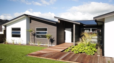 Clean modern lines define the entry to this backyard, cottage, elevation, estate, facade, home, house, property, real estate, residential area, siding, yard, white