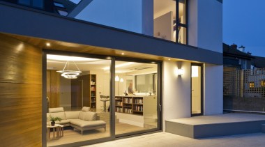 Large sliding glass doors welcome you into the architecture, building, elevation, estate, facade, home, house, property, real estate, residential area, siding, sky, window, blue