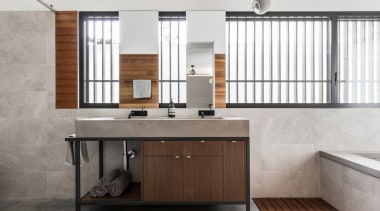 Stone, wood and tile feature throughout the bathroom. bathroom, bathroom accessory, bathroom cabinet, cabinetry, floor, furniture, interior design, product design, sink, white, gray