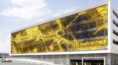 This display on the parking structure at Eskenazi architecture, building, corporate headquarters, facade, headquarters, mixed use, yellow, white