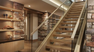 This new house, designed by Charles R Stinson interior design, shelving, stairs, brown
