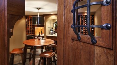 Because of its expansive and wide-open layout, a cabinetry, countertop, interior design, wine cellar, brown, red