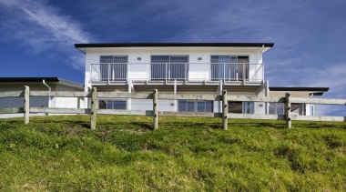 Exterior view of the house from a low cottage, estate, facade, farmhouse, home, house, land lot, property, real estate, residential area, siding, sky, villa, brown, blue