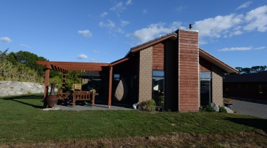 Timber weatherboard clad feature chimney. This country home architecture, cottage, elevation, facade, home, house, landscape, property, real estate, residential area, sky, blue, brown
