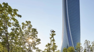 The new tower rises up above Milan - architecture, building, condominium, corporate headquarters, daytime, metropolitan area, sky, skyscraper, tower, tower block, tree, teal