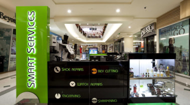 Kiosk with a green signage and green neon interior design, product, retail, black