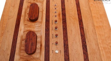 Game on! This retro-styled coffee table is a floor, flooring, hardwood, lumber, wood, wood stain, orange, red