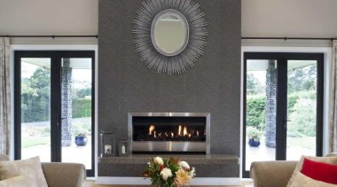 Warm neutral tones create a tranquil interior for ceiling, fireplace, floor, hearth, home, interior design, living room, room, table, gray